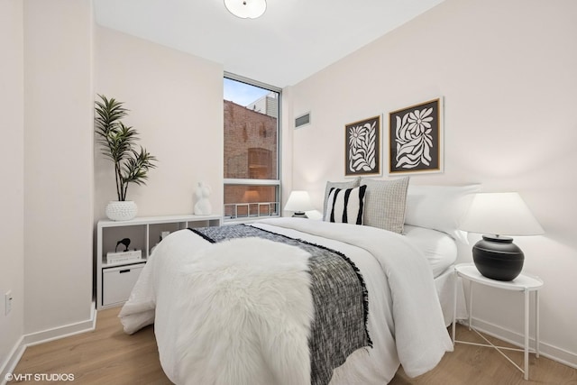 330 W Grand Ave Unit 904, Chicago, IL 60654 - bedroom featuring wood finished floors and floor to ceiling windows