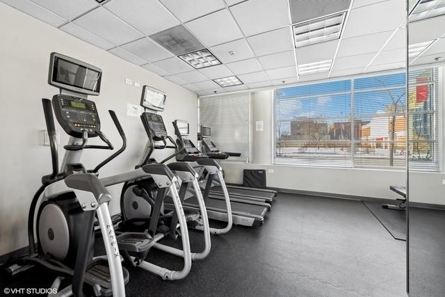 330 W Grand Ave Unit 904, Chicago, IL 60654 - gym with baseboards and a paneled ceiling