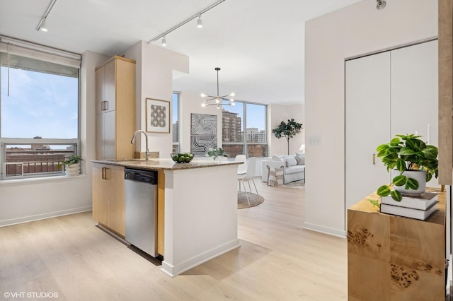 330 W Grand Ave Unit 904, Chicago, IL 60654 - kitchen with dishwasher, rail lighting, light wood-style floors, and light stone counters