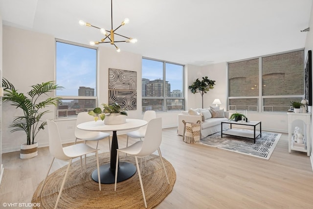 330 W Grand Ave Unit 904, Chicago, IL 60654 - dining area with light wood-style flooring, a chandelier, and a view of skyline