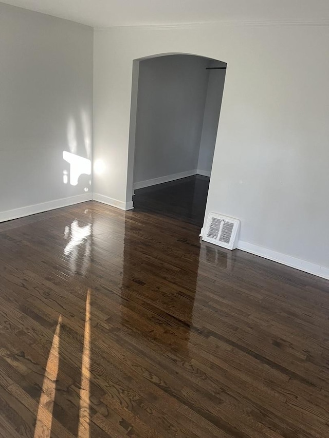 9611 S Chappel Ave, Chicago, IL 60617 - spare room featuring arched walkways and dark wood-style flooring