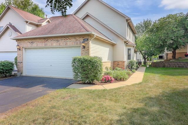 2007 Thornwood Cir, Saint Charles, IL 60174 - traditional-style house featuring brick siding, driveway, a front lawn, an attached garage, and a shingled roof