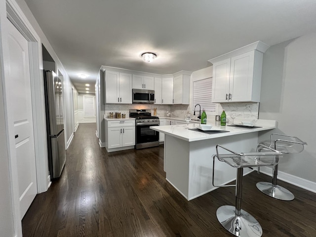 12837 S Aberdeen St, Calumet Park, IL 60827 - kitchen featuring stainless steel appliances, white cabinets, a peninsula, and light countertops