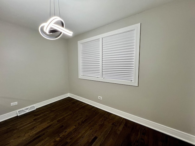 12837 S Aberdeen St, Calumet Park, IL 60827 - spare room with a chandelier and dark wood-type flooring