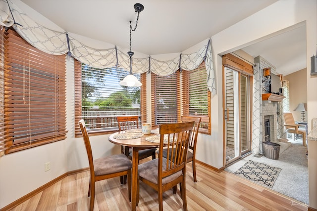 937 Wellington Cir, Aurora, IL 60506 - dining room featuring wood finished floors and a large fireplace