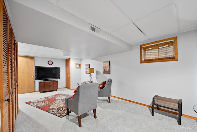 937 Wellington Cir, Aurora, IL 60506 - carpeted living area featuring a drop ceiling and baseboards