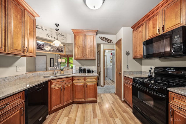 937 Wellington Cir, Aurora, IL 60506 - kitchen featuring black appliances, light wood finished floors, brown cabinetry, and light stone countertops