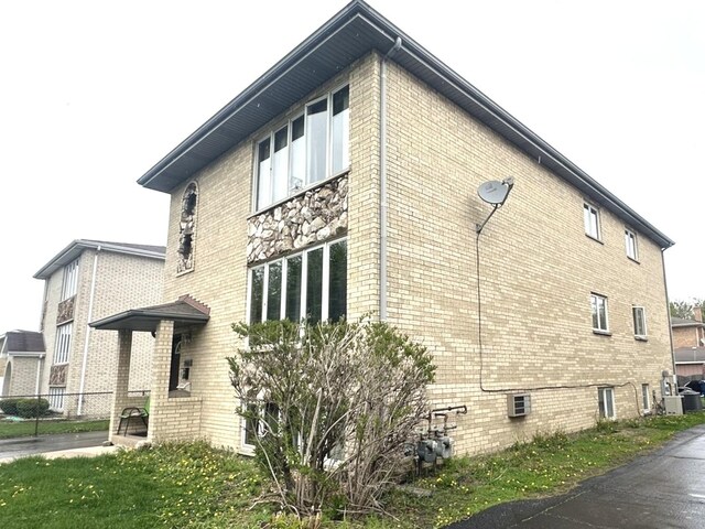 12211 S Spencer St, Alsip, IL 60803 - view of property exterior with brick siding and a central AC unit