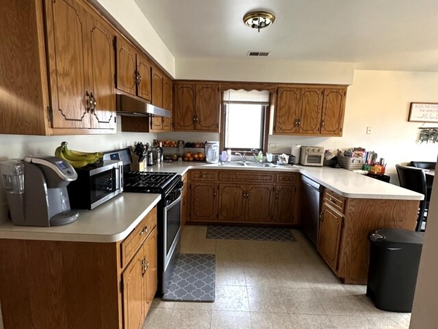 12211 S Spencer St, Alsip, IL 60803 - kitchen with stainless steel appliances, a peninsula, under cabinet range hood, light countertops, and brown cabinets