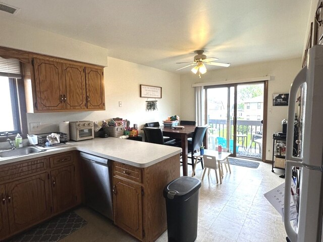 12211 S Spencer St, Alsip, IL 60803 - kitchen with dishwasher, freestanding refrigerator, a peninsula, a ceiling fan, and light countertops