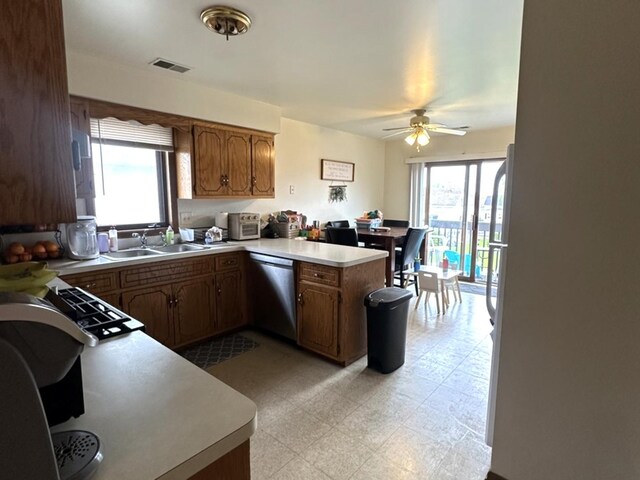 12211 S Spencer St, Alsip, IL 60803 - kitchen with stainless steel dishwasher, a peninsula, light countertops, a ceiling fan, and light flooring