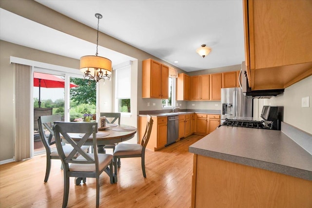 2420 Columbia Ln, Montgomery, IL 60538 - kitchen featuring appliances with stainless steel finishes, light wood-type flooring, a chandelier, and hanging light fixtures