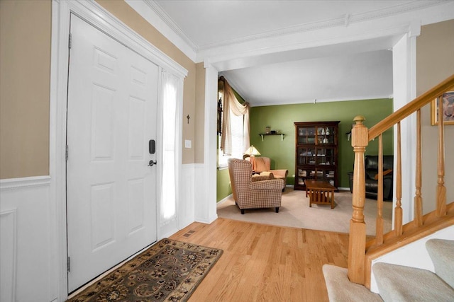 2420 Columbia Ln, Montgomery, IL 60538 - foyer entrance with stairs, wood finished floors, crown molding, and wainscoting