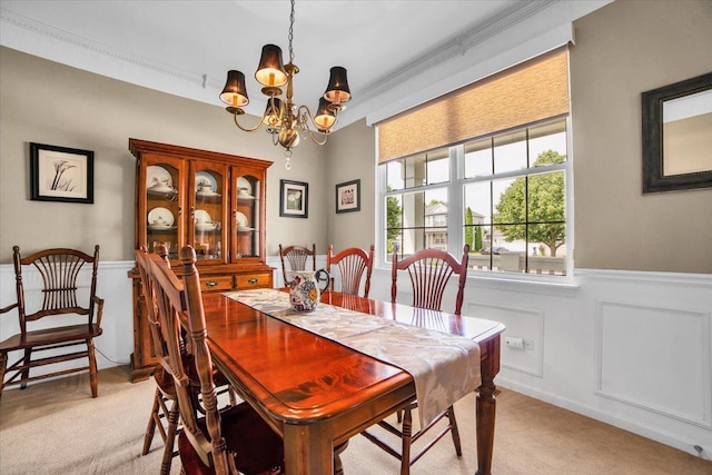 2420 Columbia Ln, Montgomery, IL 60538 - dining area featuring light carpet, a chandelier, wainscoting, and crown molding