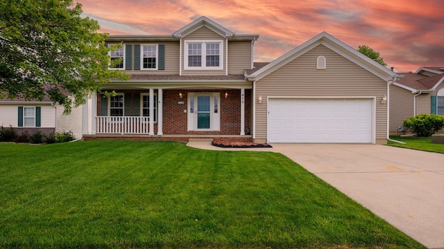 410 Wildberry Dr, Normal, IL 61761 - traditional-style house with a porch, a garage, concrete driveway, and a yard