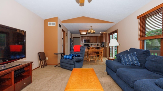 410 Wildberry Dr, Normal, IL 61761 - living room with a ceiling fan, vaulted ceiling, light carpet, and a chandelier