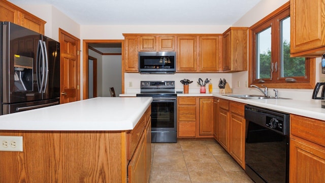 410 Wildberry Dr, Normal, IL 61761 - kitchen featuring black appliances, a center island, light countertops, and brown cabinets