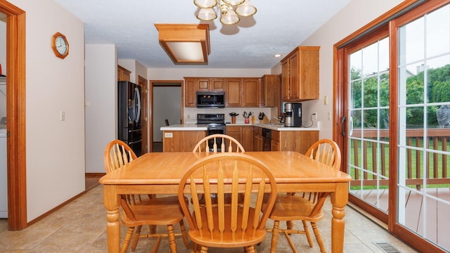410 Wildberry Dr, Normal, IL 61761 - dining space featuring a chandelier and light tile patterned flooring