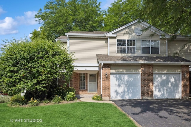 614 Hillview Ct, West Chicago, IL 60185 - view of front of house with driveway, an attached garage, brick siding, and a front yard