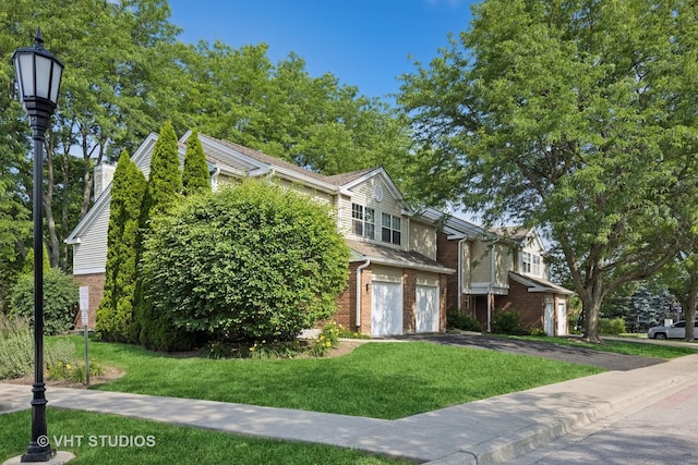 614 Hillview Ct, West Chicago, IL 60185 - view of front of property with brick siding, a front yard, asphalt driveway, and a garage
