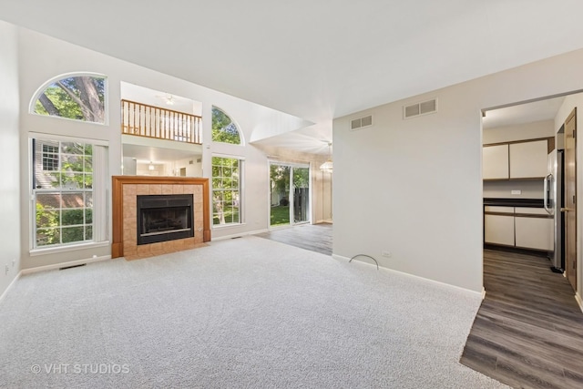 614 Hillview Ct, West Chicago, IL 60185 - unfurnished living room with plenty of natural light, a fireplace, and carpet floors