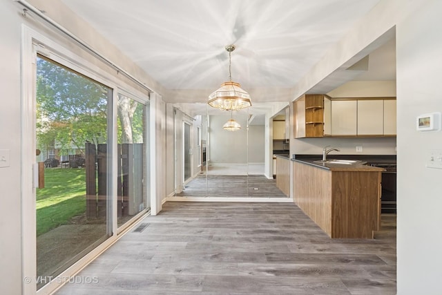 614 Hillview Ct, West Chicago, IL 60185 - kitchen featuring a chandelier, open shelves, dark countertops, light wood-type flooring, and decorative light fixtures