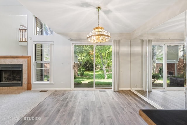 614 Hillview Ct, West Chicago, IL 60185 - doorway featuring a chandelier, wood finished floors, and a tiled fireplace