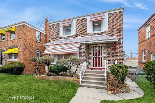9739 S Ellis Ave, Chicago, IL 60628 - multi unit property with brick siding, a gate, and a front lawn