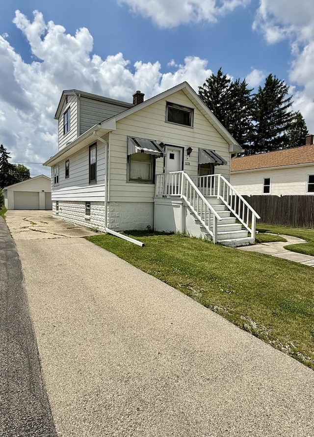 1221 Nicholson St, Joliet, IL 60435 - bungalow-style house featuring a chimney, an outdoor structure, and a detached garage