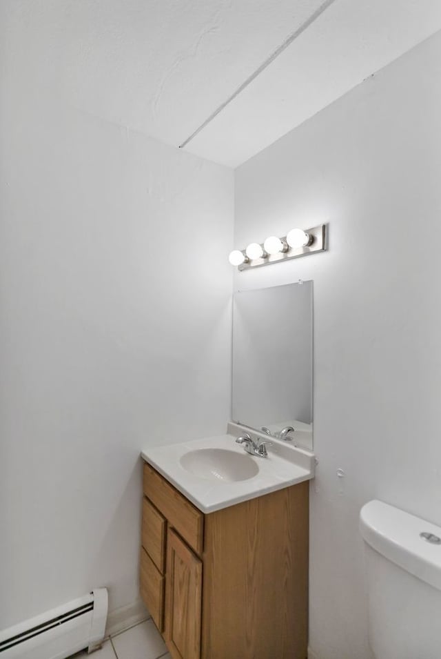 5011 Valley Ln Unit 201, Streamwood, IL 60107 - half bathroom featuring baseboard heating, vanity, and tile patterned floors