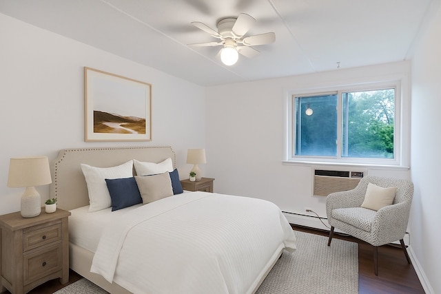 5011 Valley Ln Unit 201, Streamwood, IL 60107 - bedroom featuring an AC wall unit, a baseboard radiator, wood finished floors, and ceiling fan