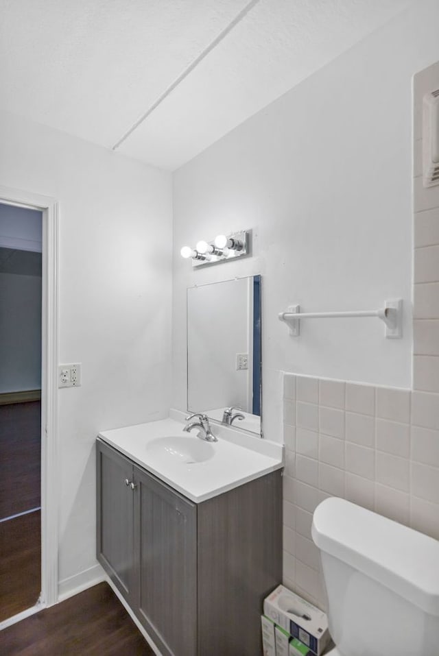 5011 Valley Ln Unit 201, Streamwood, IL 60107 - half bathroom with vanity and wood finished floors