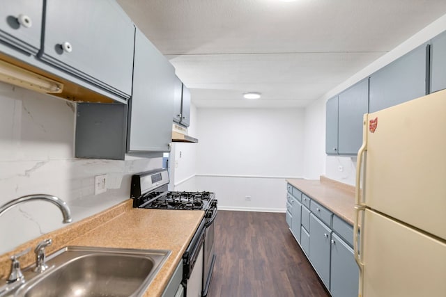 5011 Valley Ln Unit 201, Streamwood, IL 60107 - kitchen featuring freestanding refrigerator, gas stove, under cabinet range hood, dark wood-type flooring, and light countertops