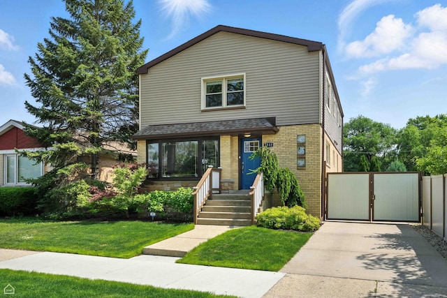 7515 W Roscoe St, Chicago, IL 60634 - view of front of house featuring brick siding, a front yard, and a gate