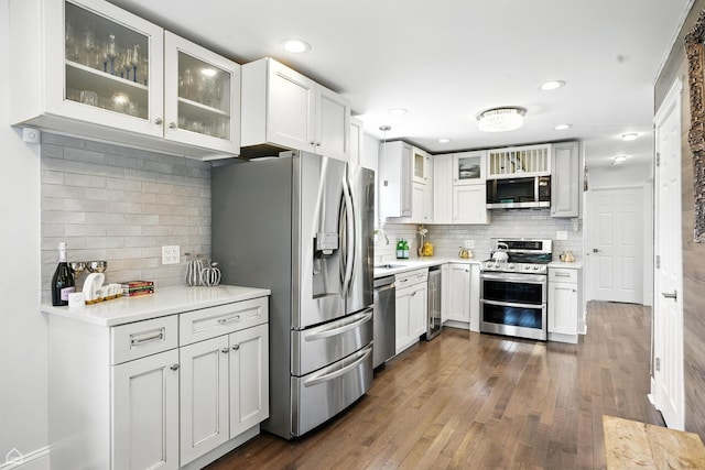 7515 W Roscoe St, Chicago, IL 60634 - kitchen featuring appliances with stainless steel finishes, tasteful backsplash, light countertops, wine cooler, and recessed lighting