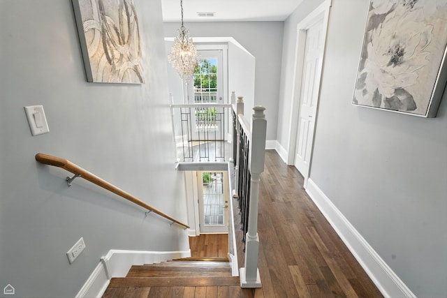 7515 W Roscoe St, Chicago, IL 60634 - staircase featuring a chandelier and hardwood / wood-style flooring