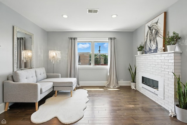 7515 W Roscoe St, Chicago, IL 60634 - sitting room featuring wood finished floors, recessed lighting, and a brick fireplace