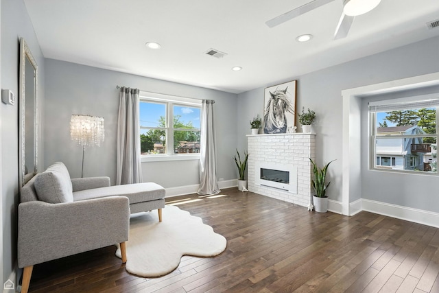 7515 W Roscoe St, Chicago, IL 60634 - living area with plenty of natural light, dark wood-style flooring, ceiling fan, a brick fireplace, and recessed lighting