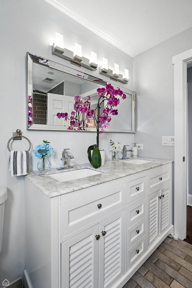 7515 W Roscoe St, Chicago, IL 60634 - bathroom featuring double vanity and wood finished floors