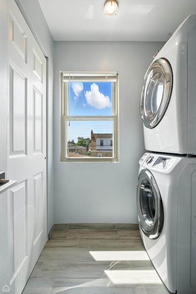 7515 W Roscoe St, Chicago, IL 60634 - laundry area featuring stacked washing machine and dryer and wood tiled floors