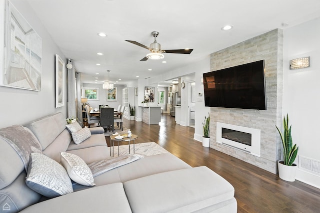 7515 W Roscoe St, Chicago, IL 60634 - living room with wood finished floors, recessed lighting, a ceiling fan, a stone fireplace, and a chandelier