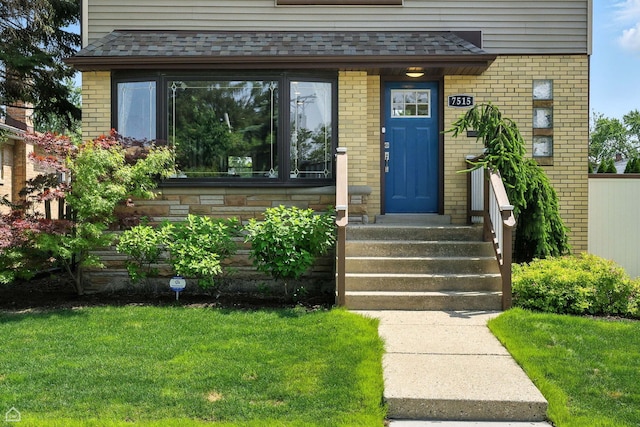 7515 W Roscoe St, Chicago, IL 60634 - doorway to property with brick siding and a shingled roof