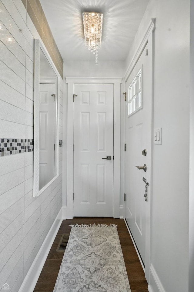 7515 W Roscoe St, Chicago, IL 60634 - doorway to outside with a chandelier and dark wood finished floors