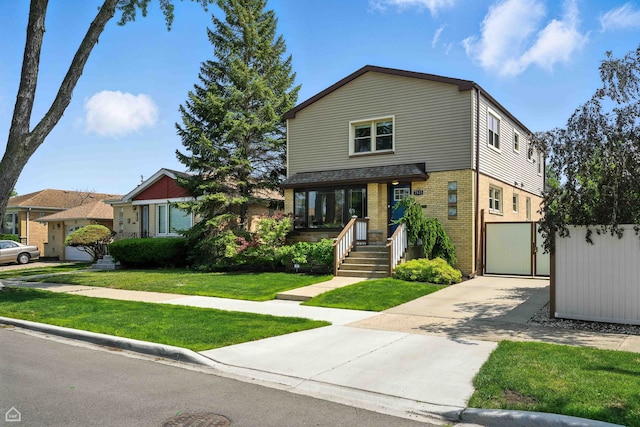 7515 W Roscoe St, Chicago, IL 60634 - view of front of property with brick siding, driveway, and a front lawn