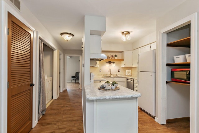 221 Barb Blvd Unit 1, Dekalb, IL 60115 - kitchen featuring freestanding refrigerator, extractor fan, white cabinetry, wood finished floors, and stainless steel dishwasher