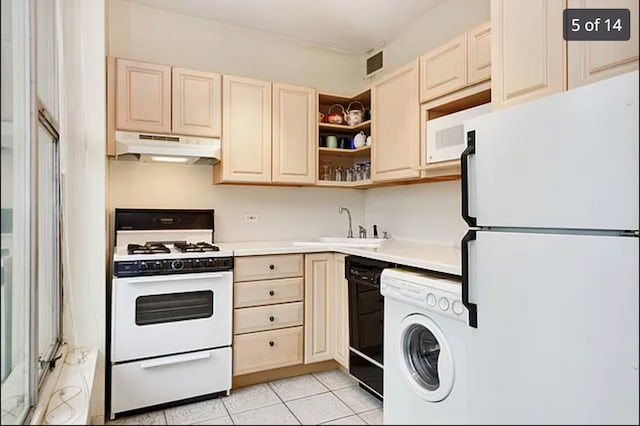 3200 N Lake Shore Dr Unit 1709, Chicago, IL 60657 - kitchen with white appliances, washer / dryer, under cabinet range hood, light countertops, and cream cabinets