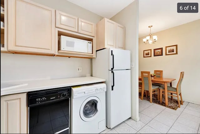 3200 N Lake Shore Dr Unit 1709, Chicago, IL 60657 - kitchen featuring washer / clothes dryer, white appliances, cream cabinetry, a chandelier, and light tile patterned floors