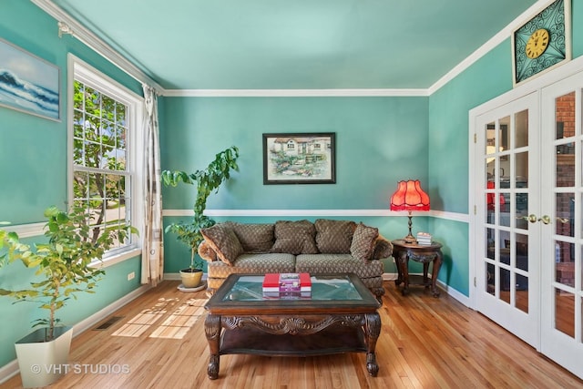 387 Essex Dr, Oswego, IL 60543 - living area with french doors, ornamental molding, and hardwood / wood-style flooring