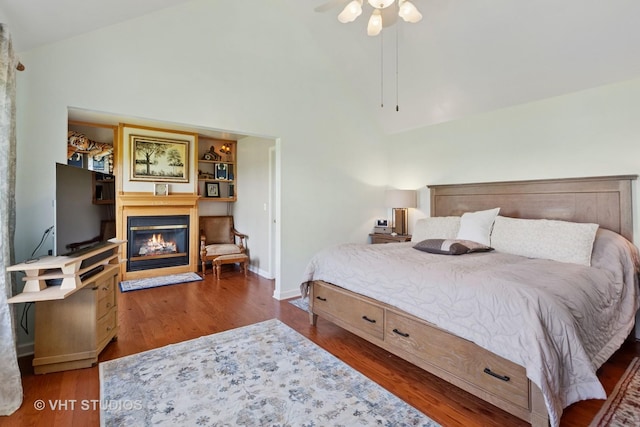 387 Essex Dr, Oswego, IL 60543 - bedroom with high vaulted ceiling, a glass covered fireplace, and wood finished floors