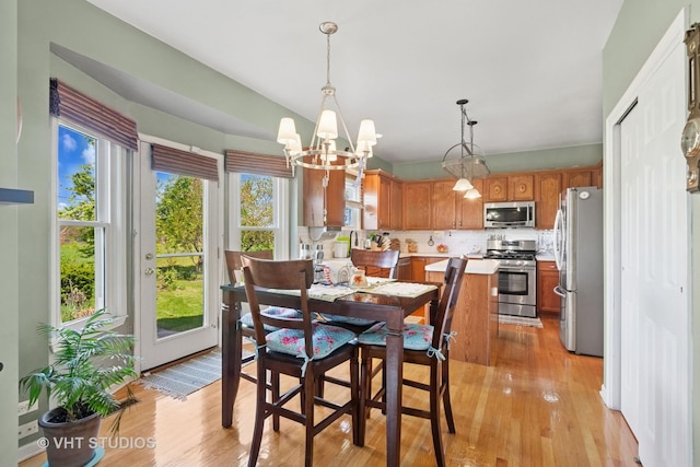 387 Essex Dr, Oswego, IL 60543 - dining space featuring a chandelier and light wood finished floors